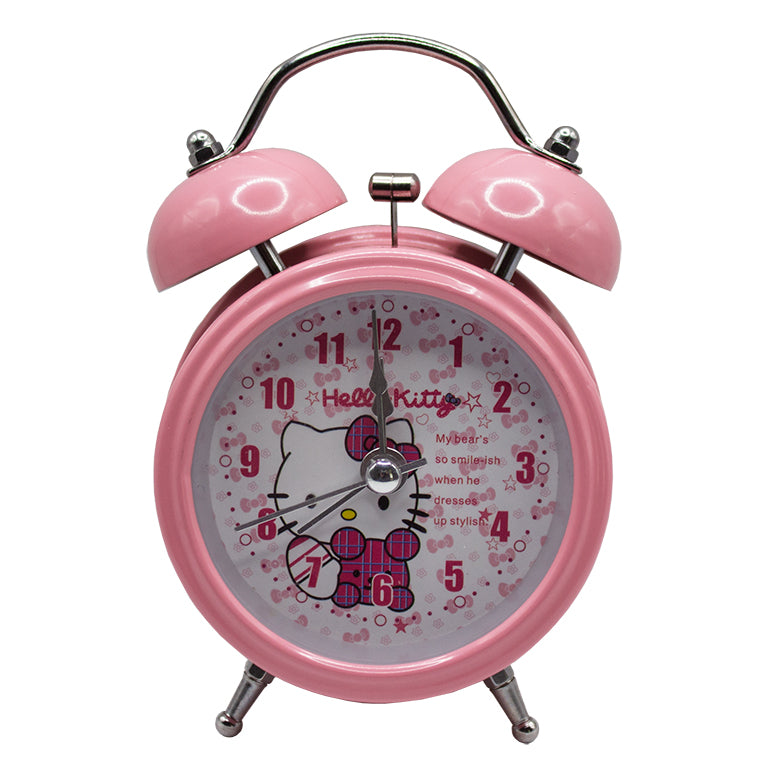 Hello Kitty pink twin bell alarm clock on a bedside table