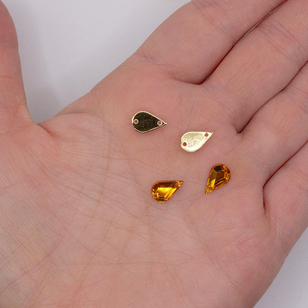 Close-up of a single 6x10mm amber gold teardrop rhinestone.