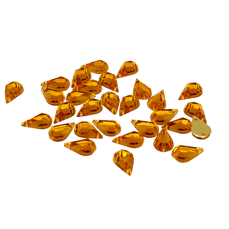 30 amber gold acrylic teardrop rhinestones on a white background.