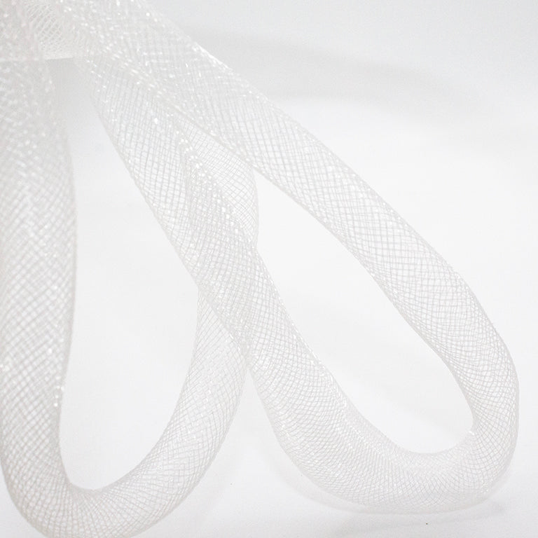 Uneven shaped white trim elastic displayed on a table