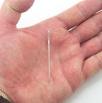 Close-up of the sharp pointed end of the large opening sewing needle.