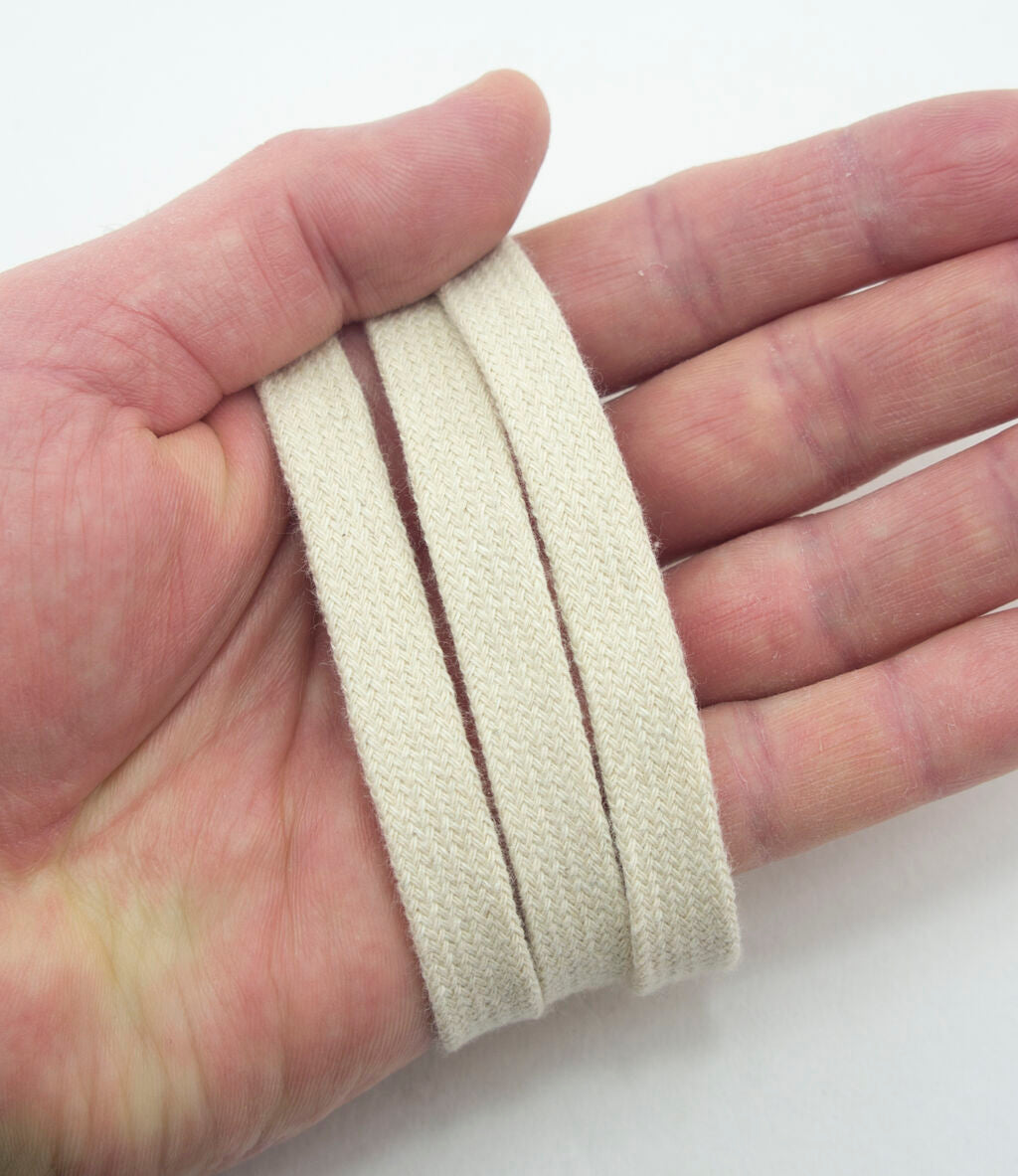 Close-up of 10 mm wide cream flat rope cord trim showing texture.