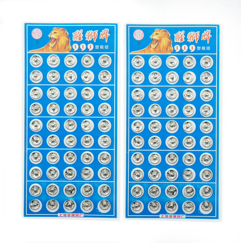 Close-up of silver metal clip buttons, 8mm wide, for sewing projects.