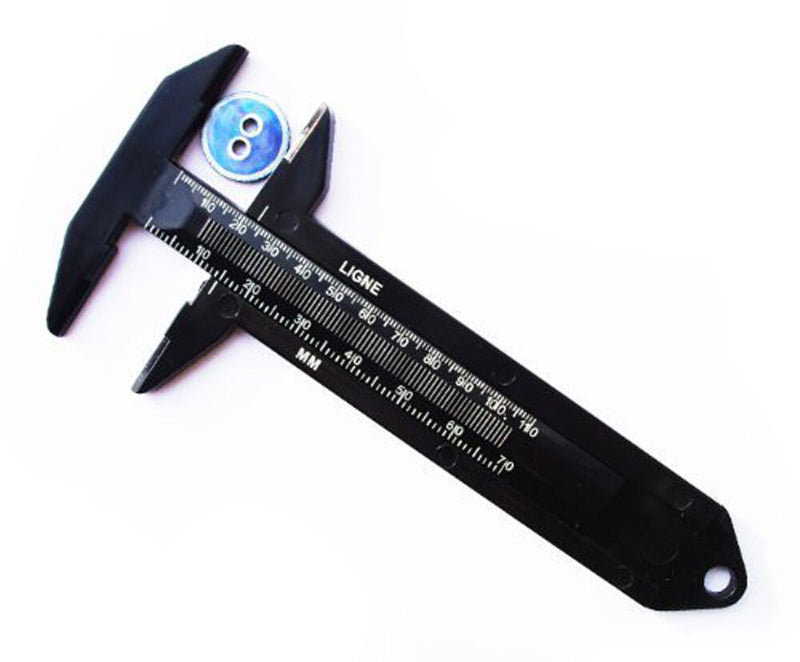 Black button measurer showing clear measurement markings