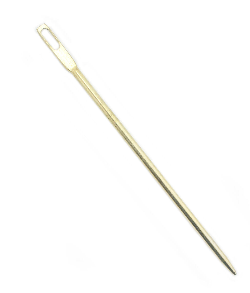 Extra large gold multi-purpose needle on a white background.
