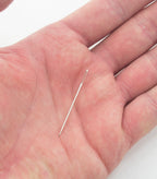 Close-up of cross stitching needles with large openings for easy threading.