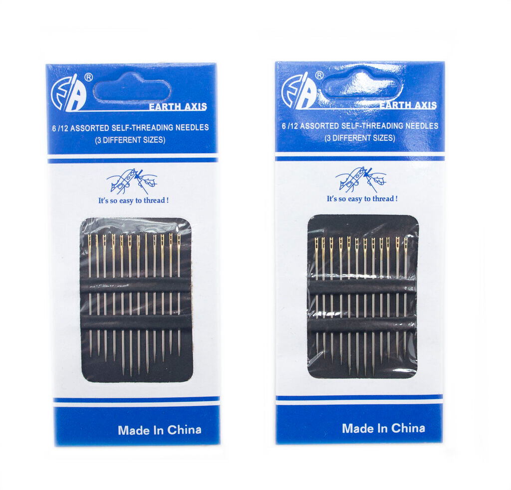 Three self threading needles of different sizes on a white background.