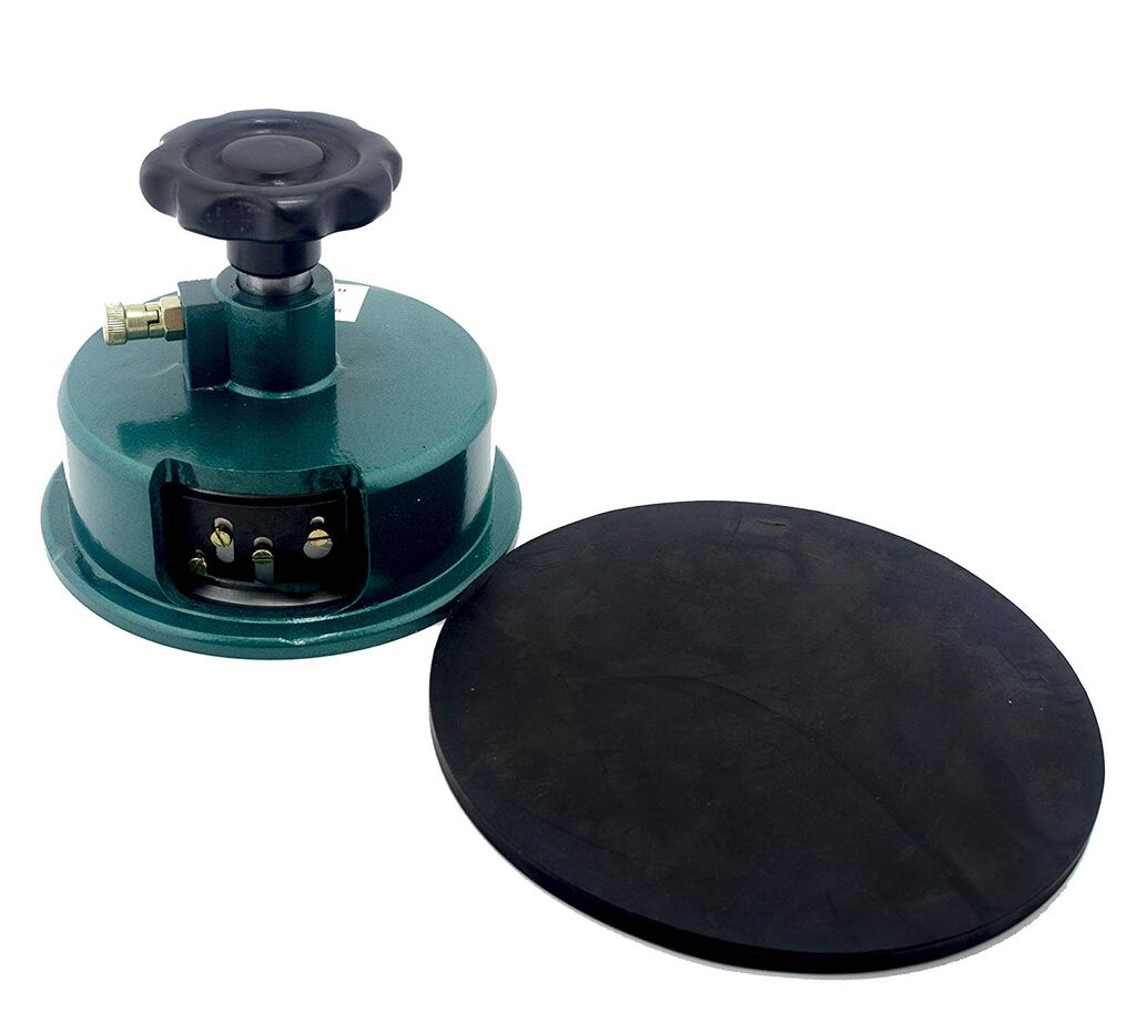 Round cutter for textile GSM sampling on a cutting mat.