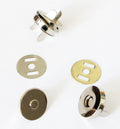 Silver magnetic button set displayed on a white background