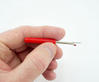 Close-up of the unpicker's sharp blade designed for precision cutting.