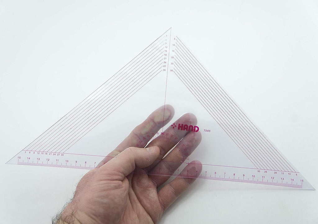 Set square ruler displayed with a measuring tape and fabric