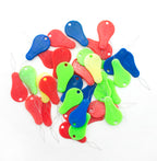 Close-up of a colourful needle threader for sewing.