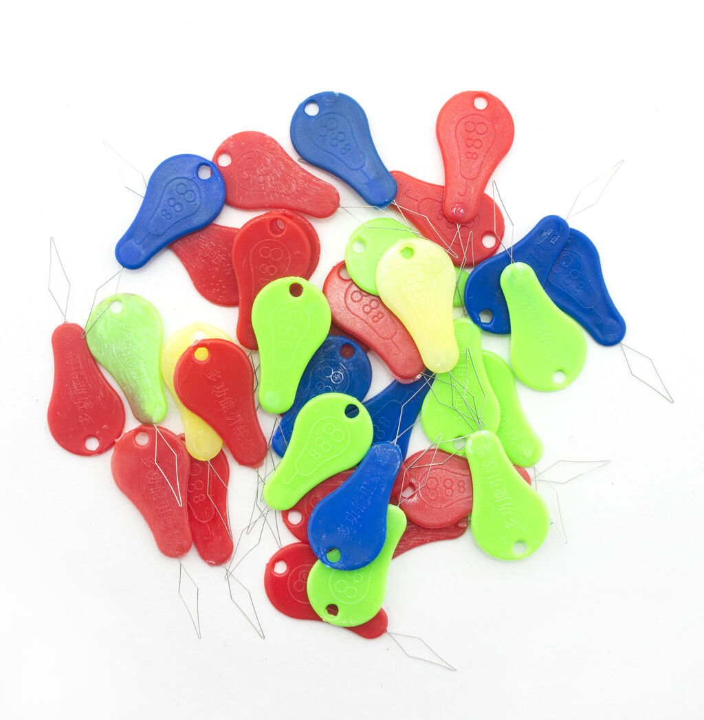 Close-up of a colourful needle threader for sewing.