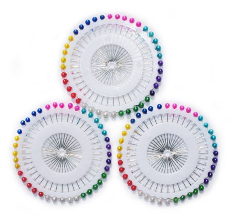 Three wheels of long pearl pins for dress making.