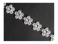 Pretty silver flowers trim displayed on a white background.