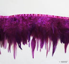 Full view of 6 inches mulberry purple duck feather trim on a roll.