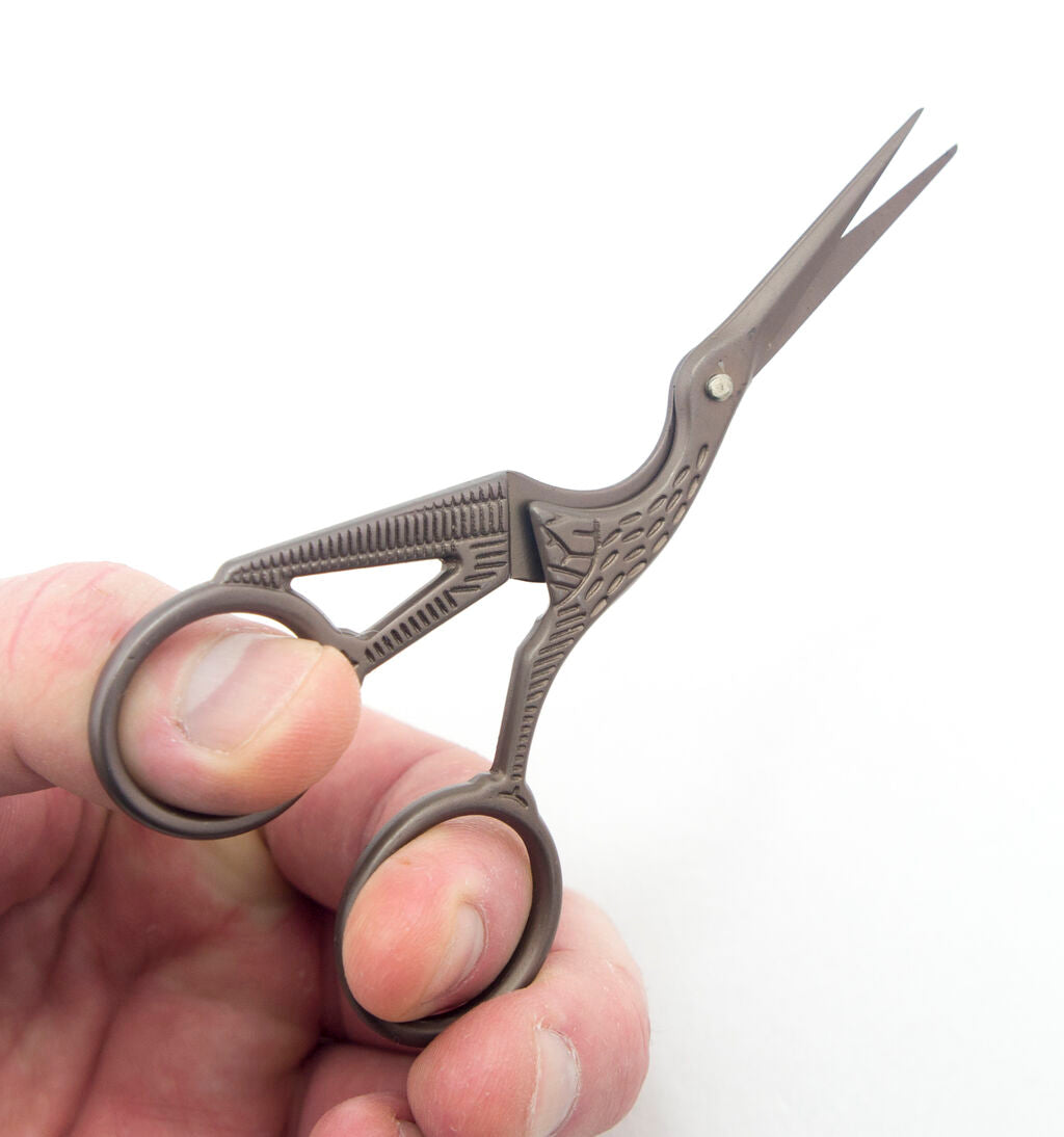 Scissors displayed on a fabric background, showcasing their design.