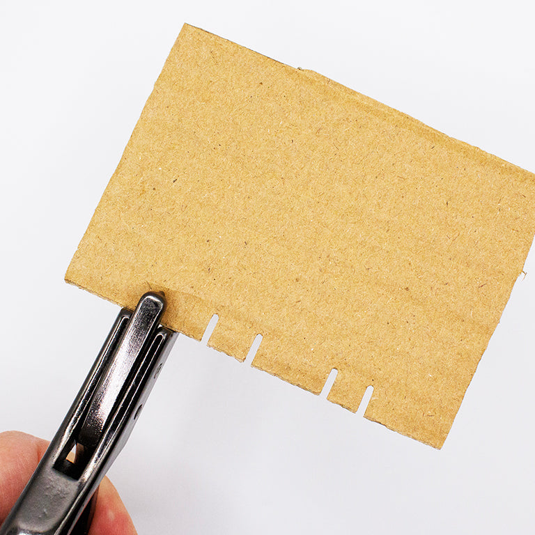 Close-up of the notching tool demonstrating its sharp cutting edge.