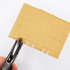 Close-up of the notching tool demonstrating its sharp cutting edge.