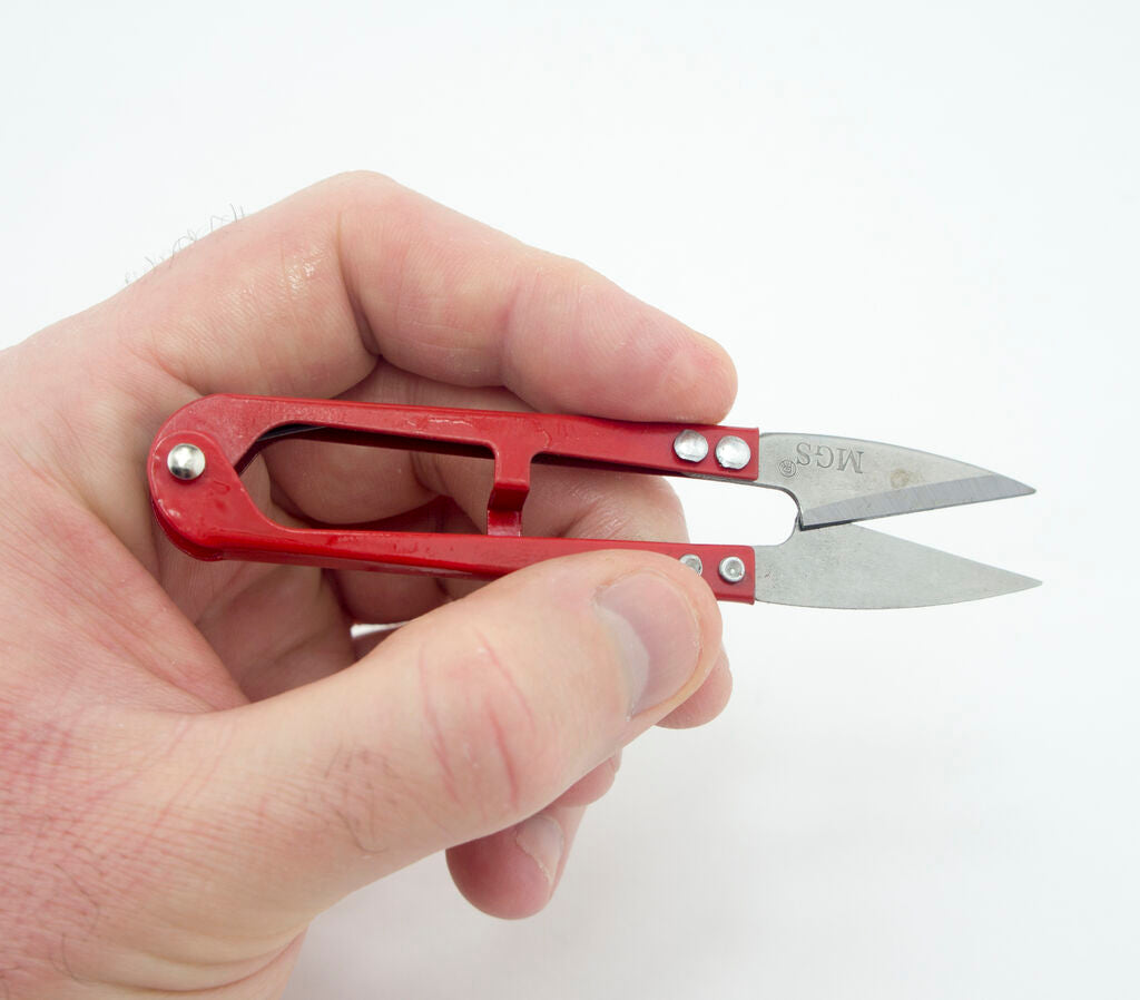 User demonstrating the snips in action on fabric