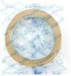 Roll of double sided tape on a craft table with tools.