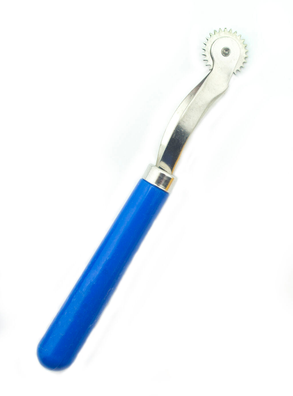 Serrated tracing wheel on a cutting mat for sewing projects.