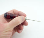 Close-up of a stitching awl showing the sharp blade and handle.
