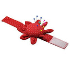 Wrist pin cushion displayed on a sewing table with fabric