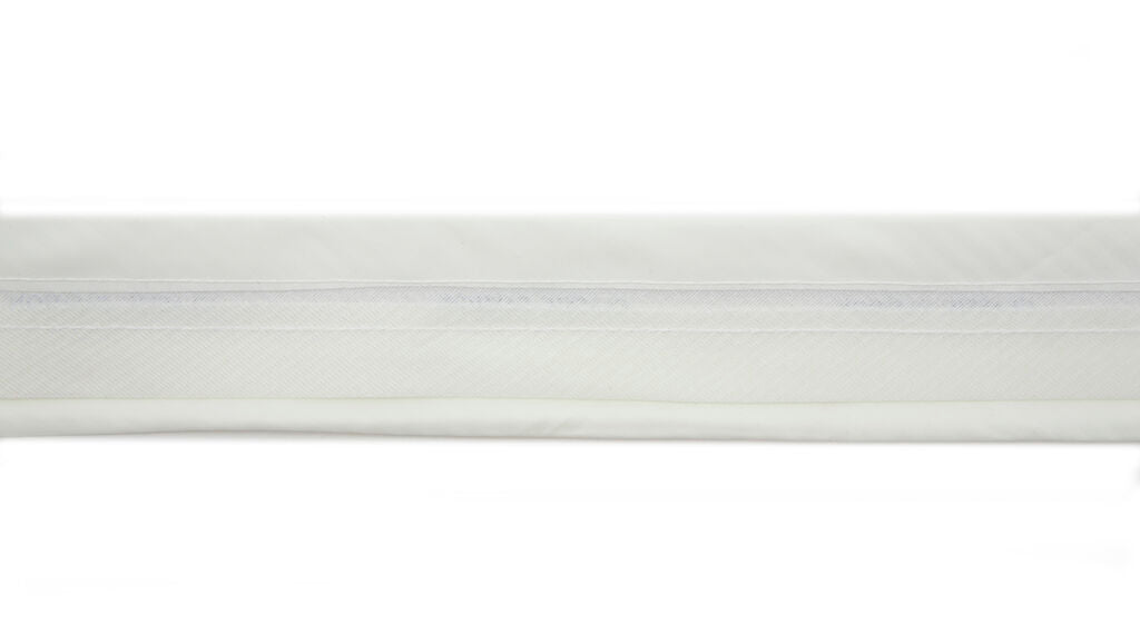 Close-up of cream silk satin fabric showing smooth texture.