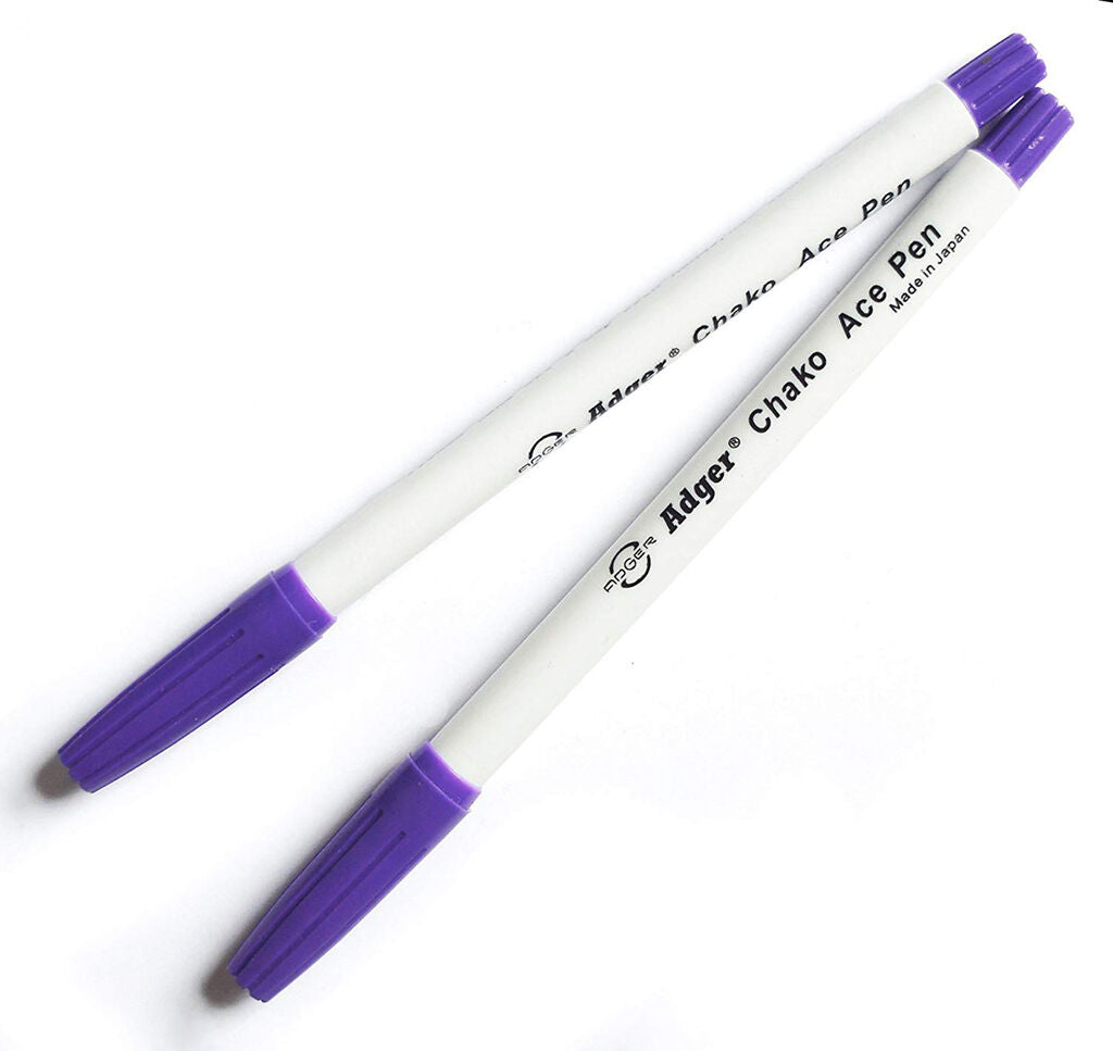 Pack of two fabric marker pens on a crafting table
