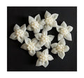 Pack of 8 white decorative flowers with pearl accents.