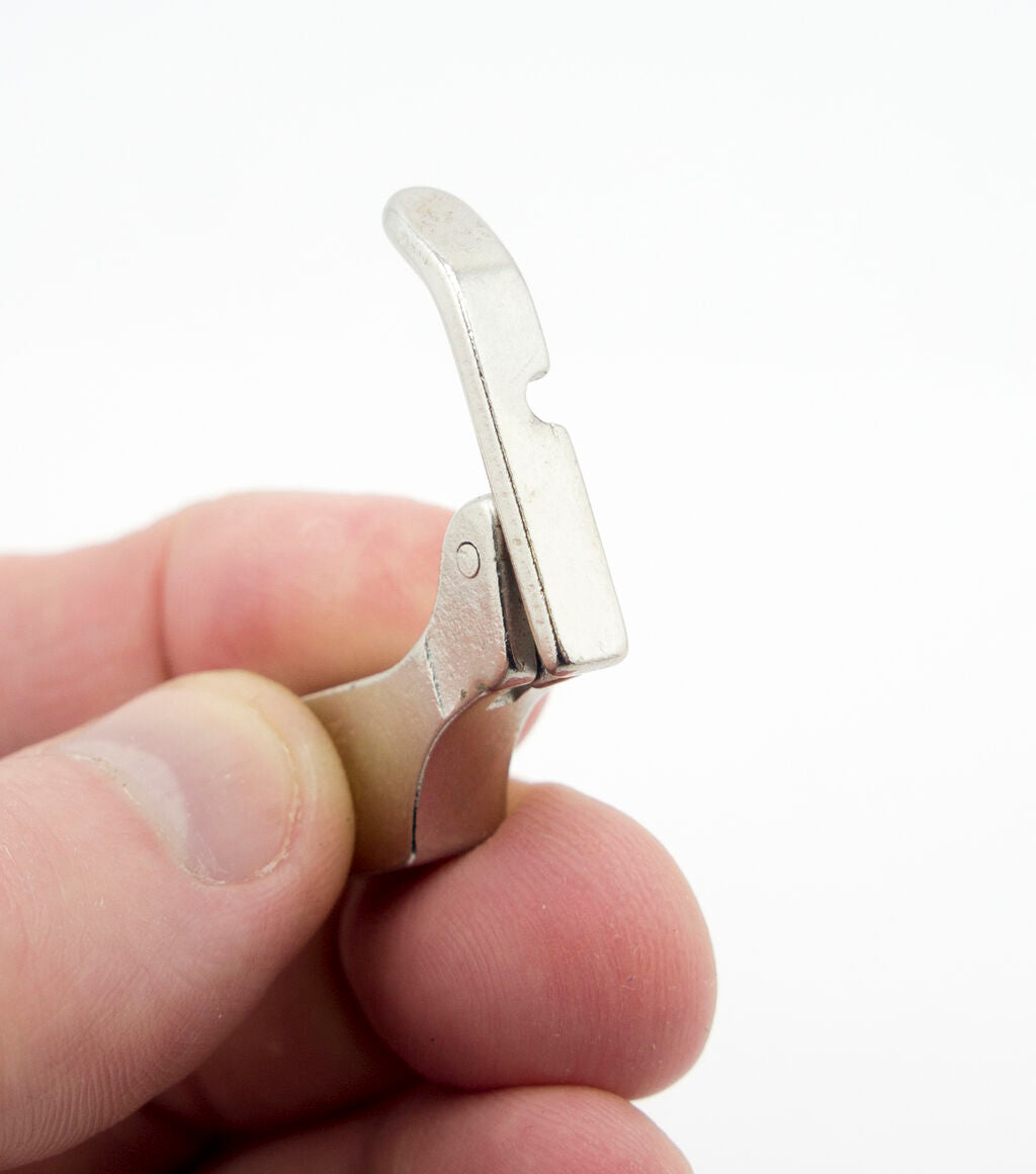 Close-up of the industrial sewing machine zipper foot.