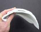 Close-up view of the white men's shoulder pads showing texture.