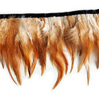 Natural brown and white rooster feather fringe trim on a roll.