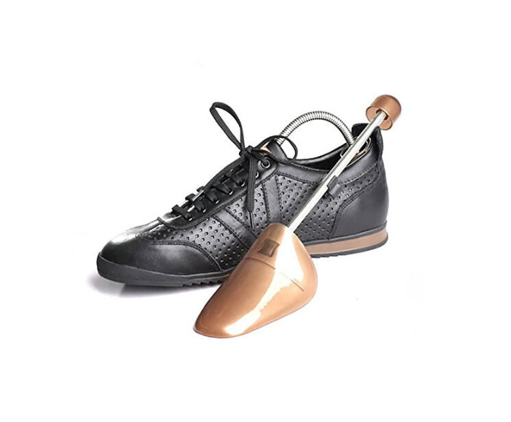 Shoe expander placed inside a brown leather shoe