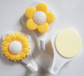 Three sunflower self adhesive hooks in yellow, designed for easy attachment.