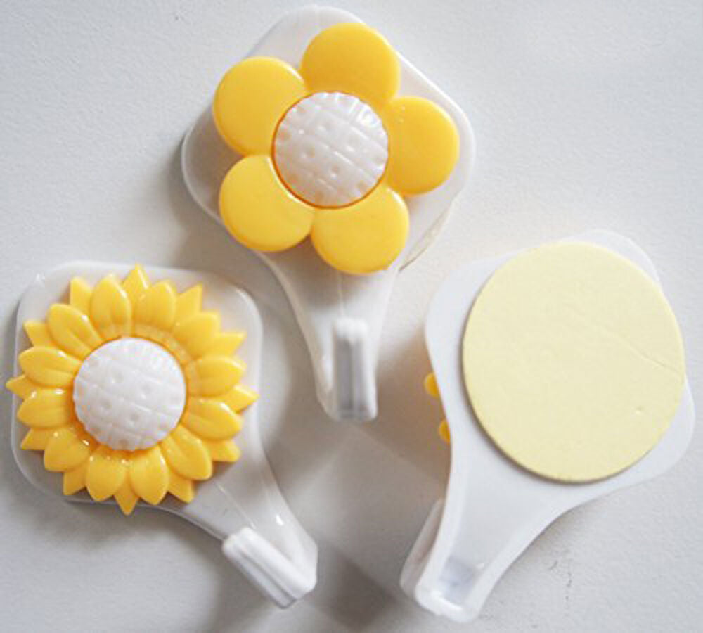 Three sunflower self adhesive hooks in yellow, designed for easy attachment.