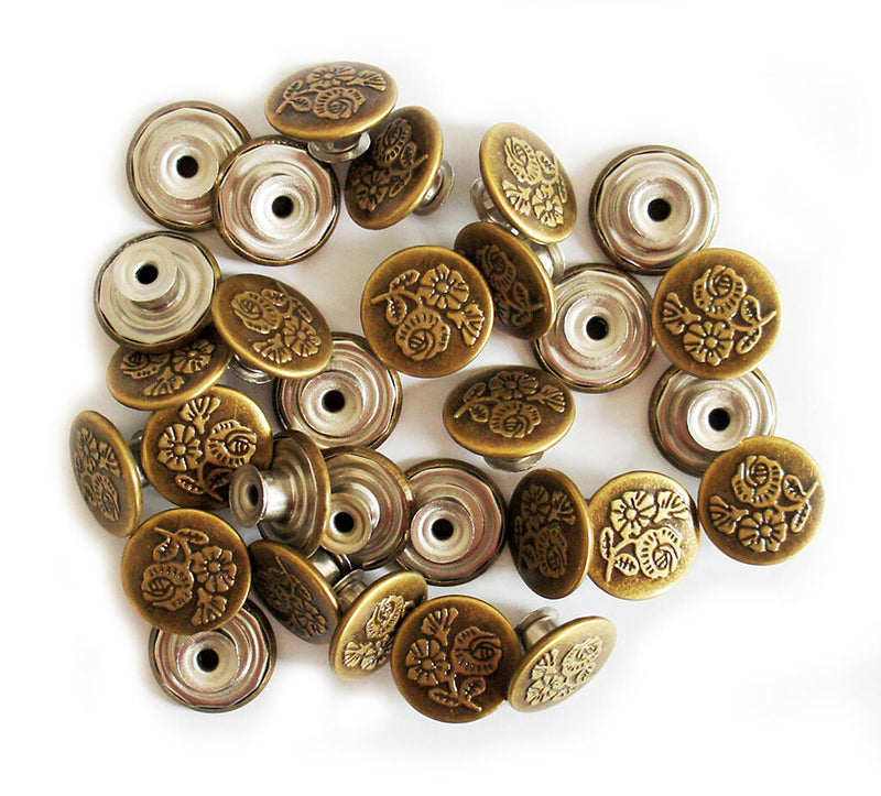 Vintage gold flower design jeans button on a white background