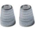 Two Slip-Stop silver finger tip thimbles on a white background.