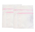 Four large tough zipped laundry bags in white, two sizes included.