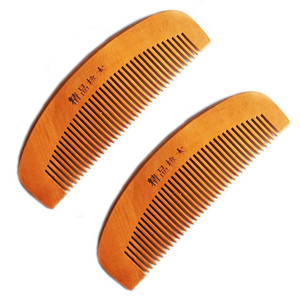 Two natural peach wood combs displayed side by side.