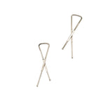 Close-up of silver small metal garment shirt cross clips for sewing.