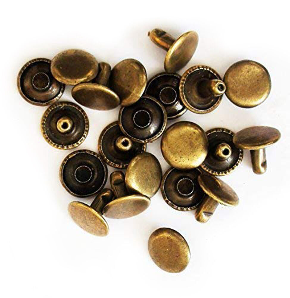 Close-up of 12mm plain vintage gold press studs in a pack.