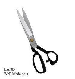 Tailors scissors displayed with fabric swatches for cutting.