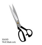 Tailors scissors displayed with fabric swatches for cutting.