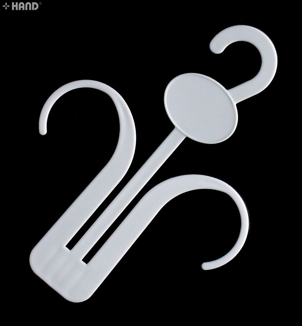 Close-up of a plastic white shoe hanger holding a slipper